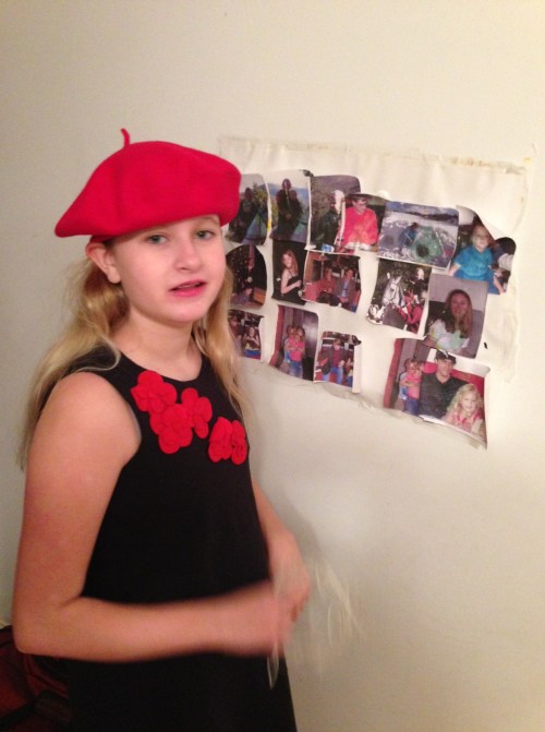 Emma showing off her new red beret and her new art work (a collage of relatives).